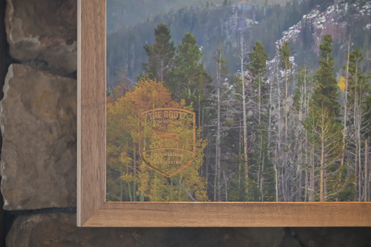 Framed artwork of a forest scene with a mountain in the background