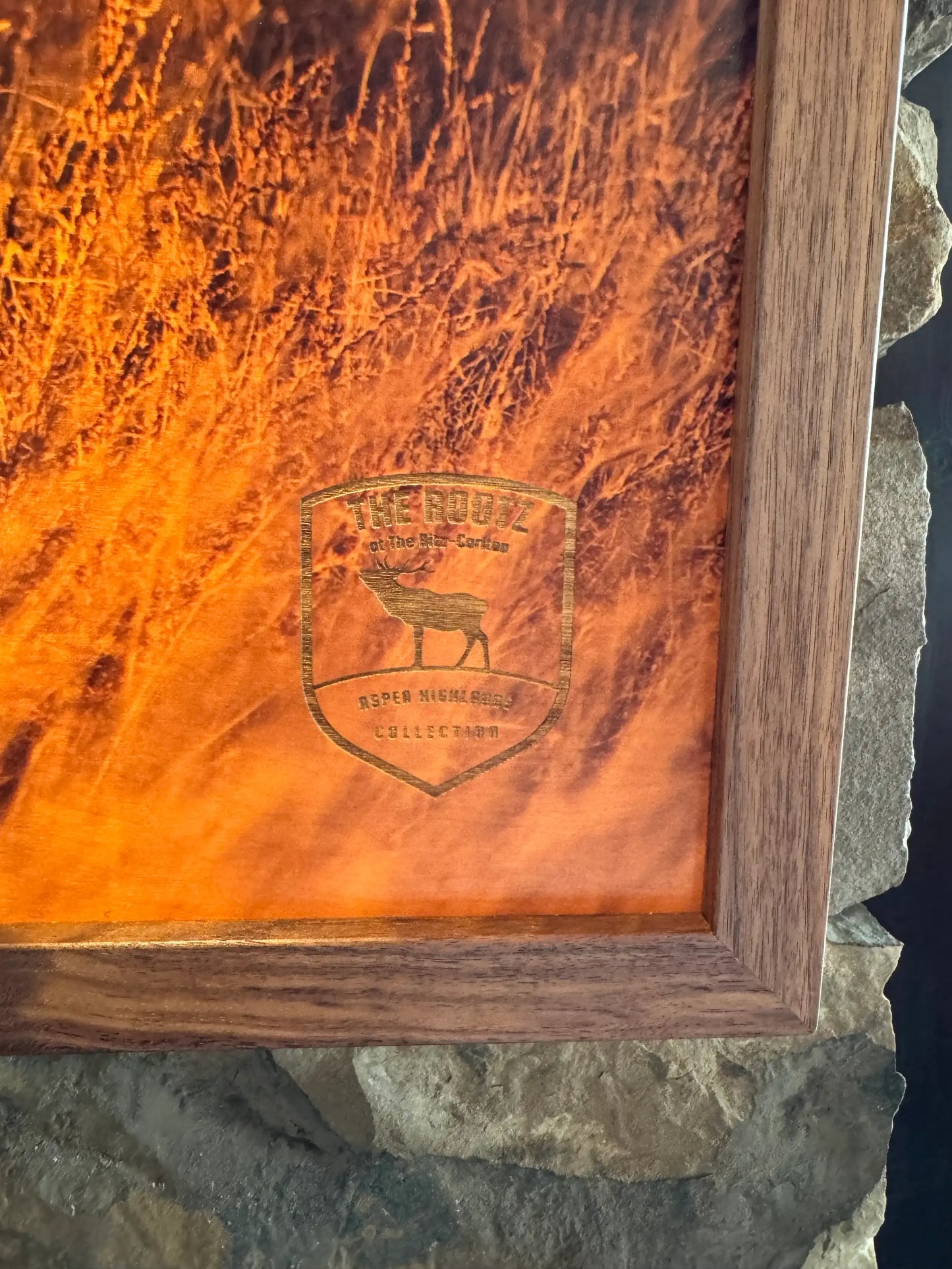 Wooden print with engraved logo on a stone surface