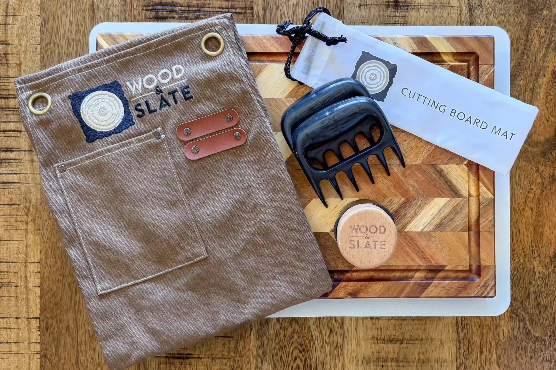 Brown leather pouch, black metal tool, and wooden cutting board on a wooden surface