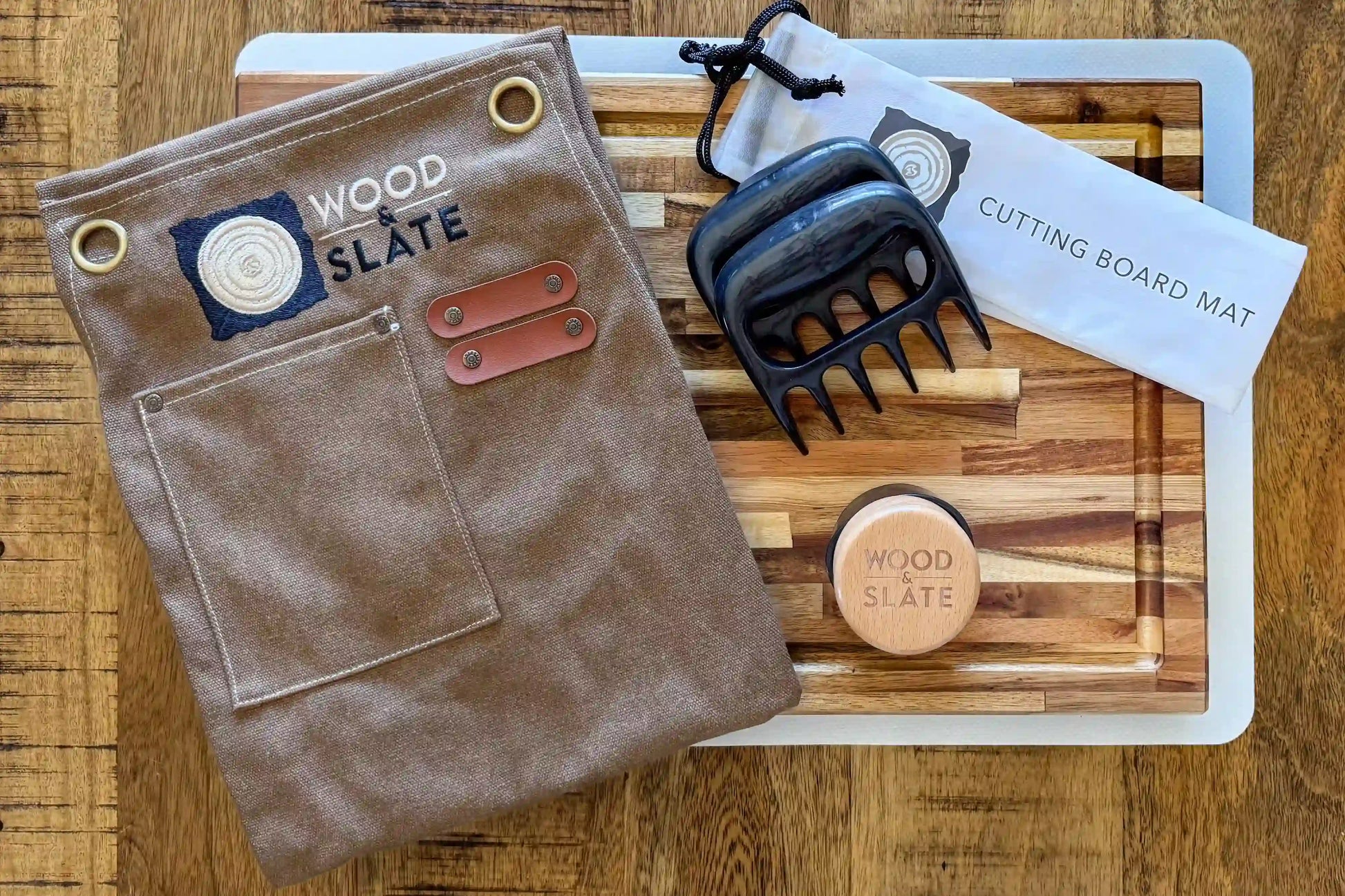 Brown leather pouch, wooden cutting board, and tools on a wooden surface with 'Wood & Slate' branding.